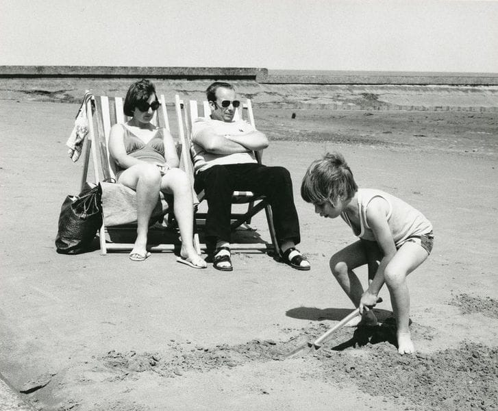 Description : 'Family Holiday', Black and white photograph mounted on card, by John Heywood, 1979.